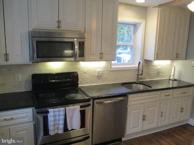 kitchen with sink, stainless steel appliances, and white cabinetry