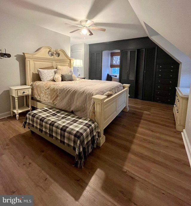 bedroom featuring ceiling fan, dark hardwood / wood-style flooring, and lofted ceiling