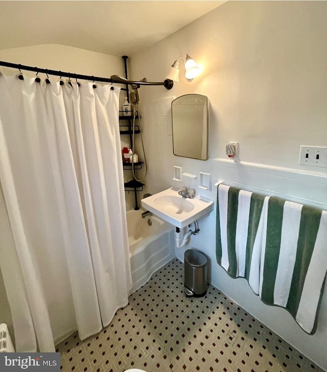 bathroom featuring sink and shower / bath combination with curtain