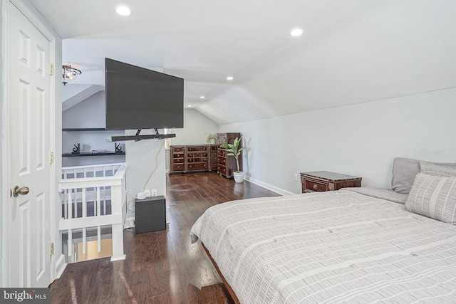 bedroom with dark wood-type flooring and lofted ceiling