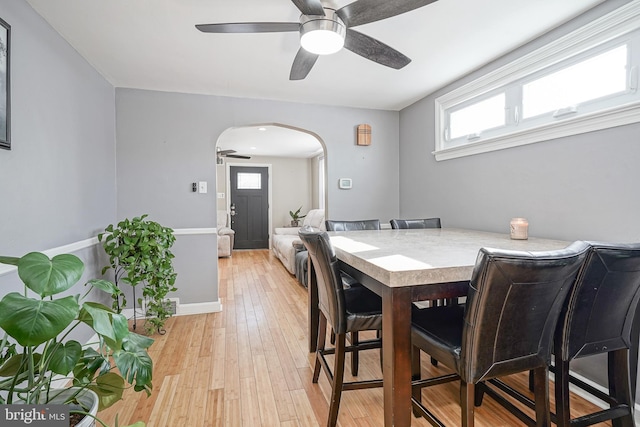 dining space with light hardwood / wood-style floors and ceiling fan