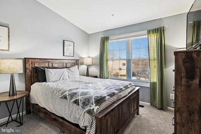 carpeted bedroom featuring lofted ceiling