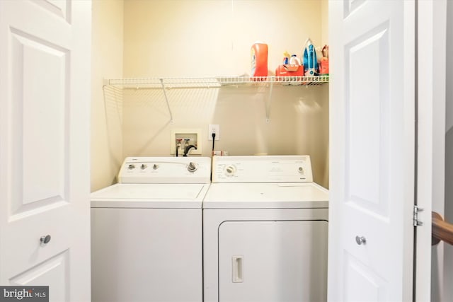 clothes washing area with washer and dryer