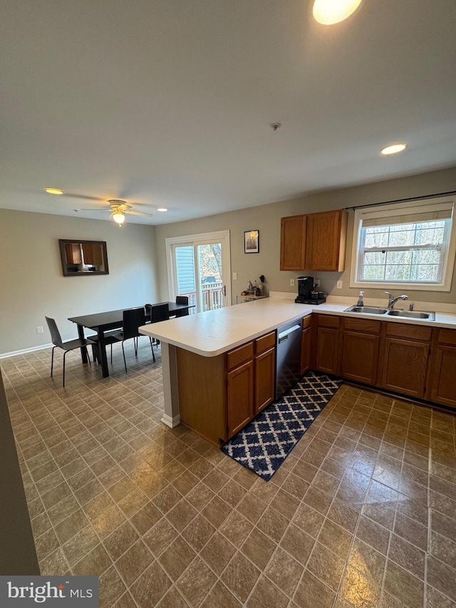 kitchen featuring sink, kitchen peninsula, dishwasher, and ceiling fan