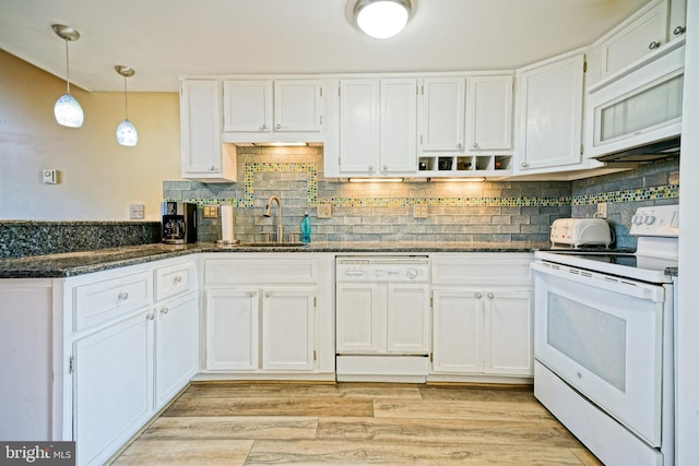 kitchen with pendant lighting, sink, white appliances, white cabinets, and dark stone counters