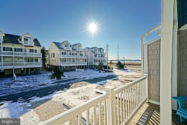 view of snow covered back of property