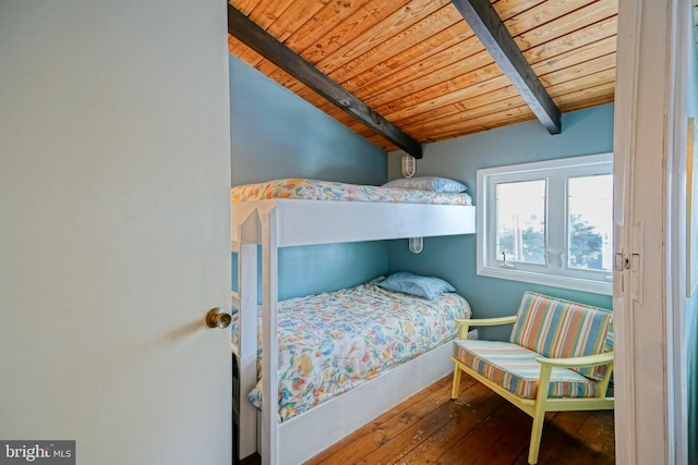 bedroom featuring lofted ceiling with beams, wood-type flooring, and wood ceiling