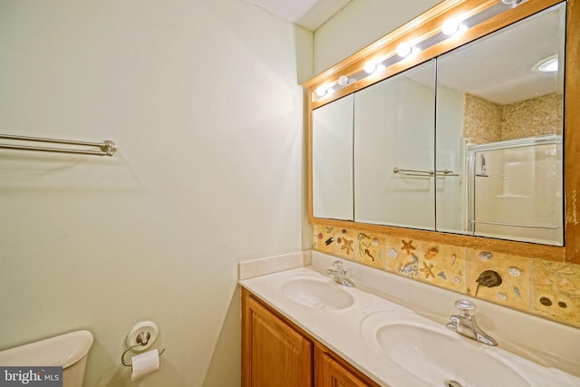 bathroom featuring vanity, toilet, and walk in shower