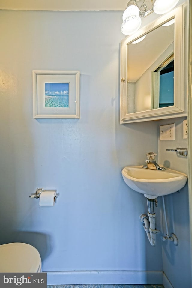 bathroom featuring sink and toilet