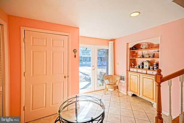 foyer with french doors and light tile patterned floors