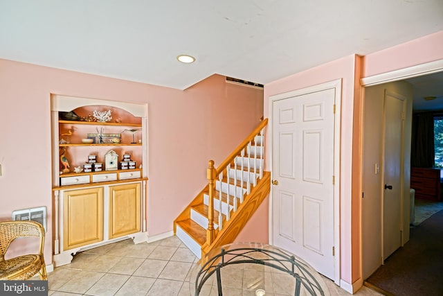 stairway with tile patterned flooring