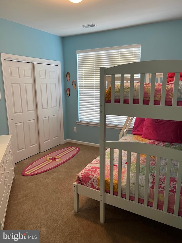 bedroom with a closet and carpet flooring