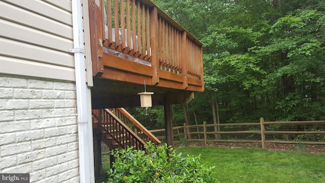 view of side of home featuring a deck and a lawn