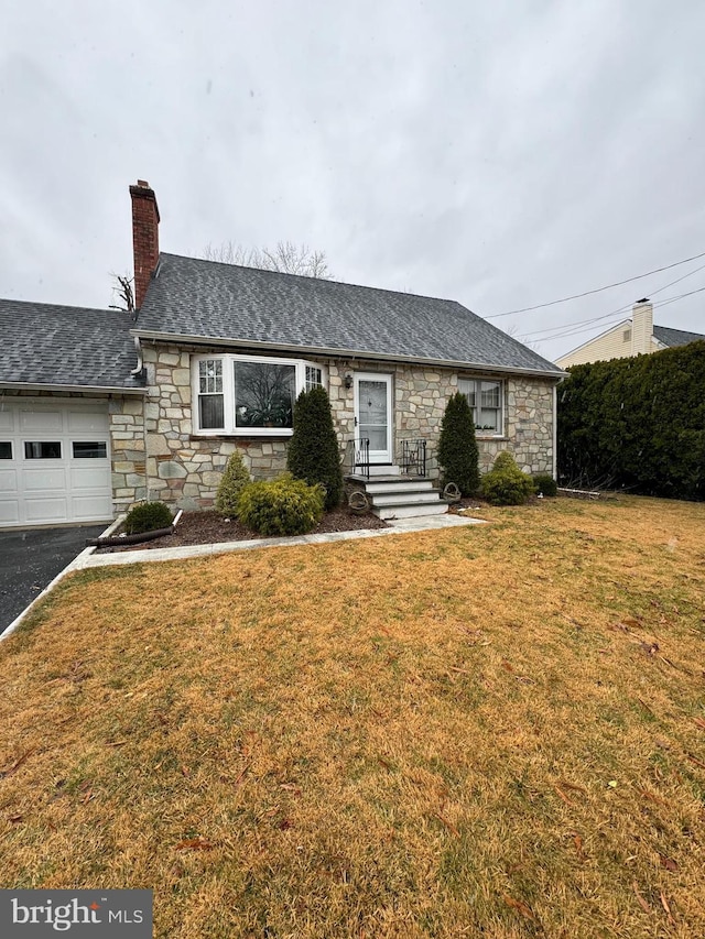 ranch-style house featuring a garage and a front yard