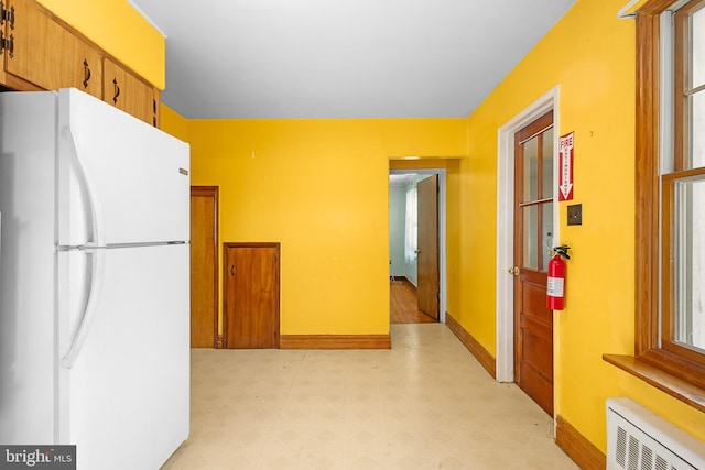 kitchen featuring white refrigerator and radiator