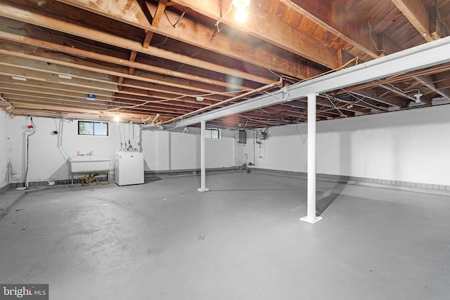 basement featuring washer / dryer and sink