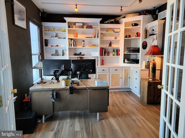 office featuring track lighting and light wood-type flooring