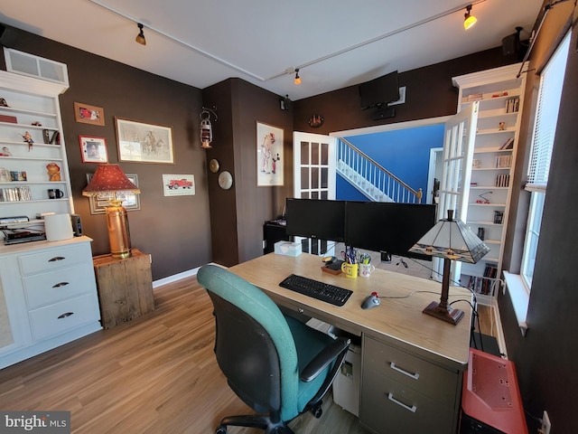 office with light hardwood / wood-style flooring