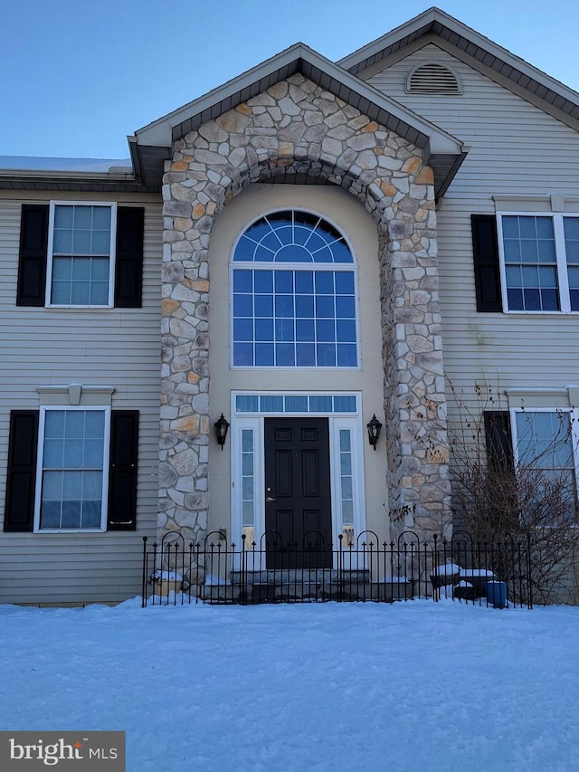 view of snow covered property entrance