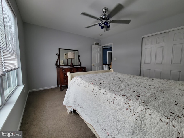 carpeted bedroom with ceiling fan and a closet