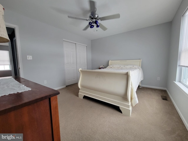 carpeted bedroom featuring a closet and ceiling fan