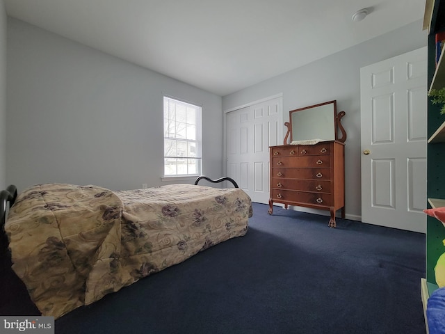 carpeted bedroom with a closet