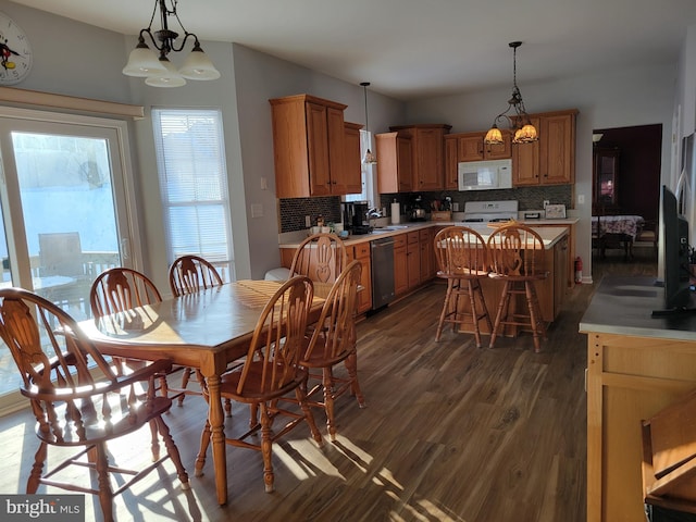 dining room with sink and dark hardwood / wood-style floors