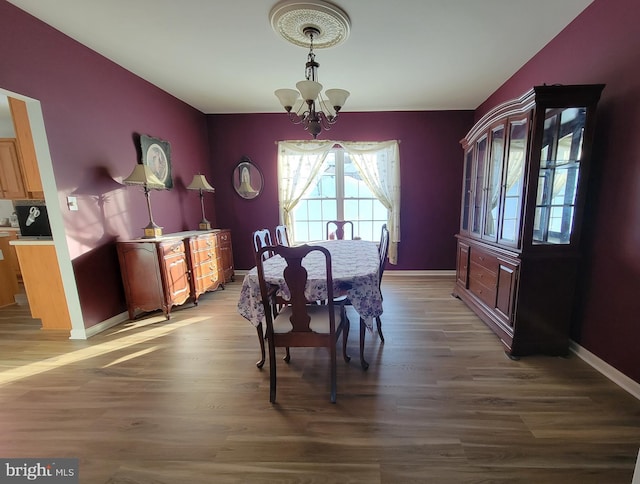 dining area with an inviting chandelier and wood-type flooring