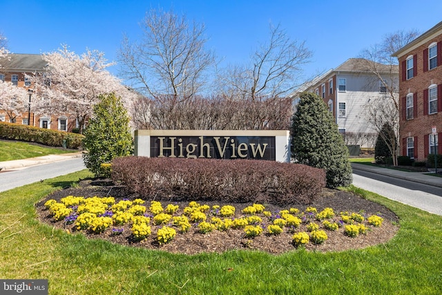 community / neighborhood sign with a yard