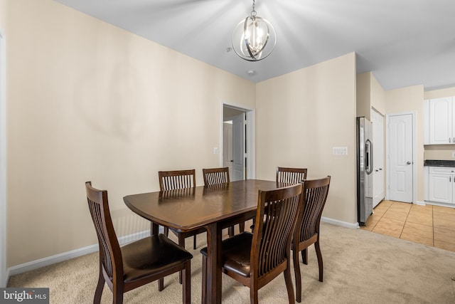 dining area with light colored carpet and an inviting chandelier