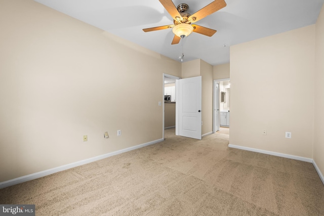 carpeted empty room featuring ceiling fan