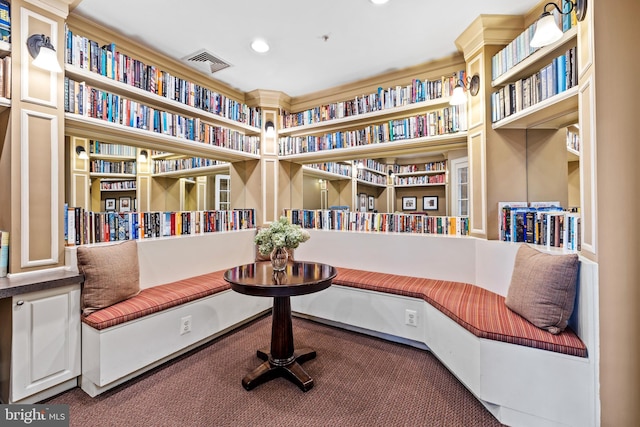 living area with built in shelves and carpet