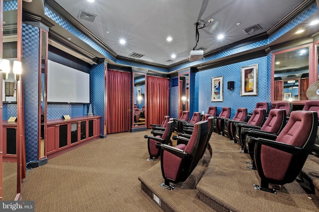 home theater room with ornamental molding and carpet