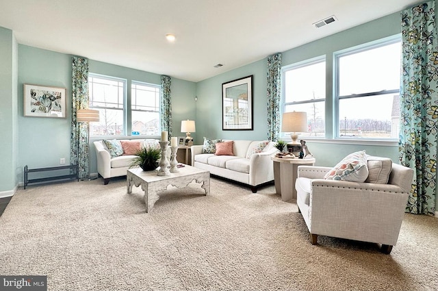 living room featuring a healthy amount of sunlight, light colored carpet, and a baseboard radiator