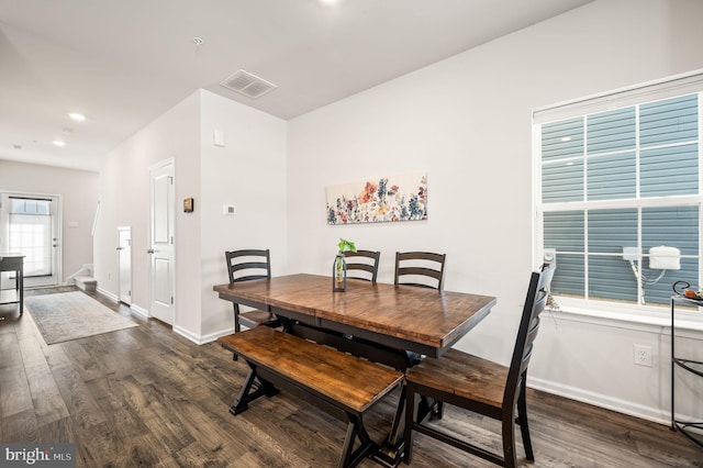 dining space featuring dark wood-type flooring