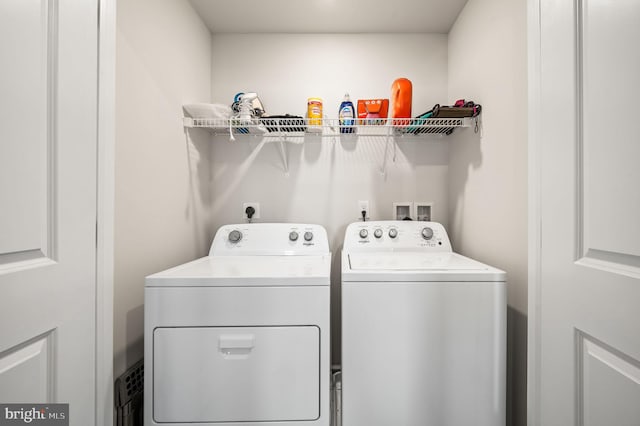 clothes washing area with washer and dryer