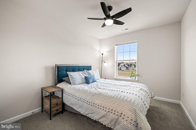 bedroom with ceiling fan and dark colored carpet