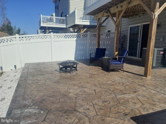 view of patio / terrace featuring an outdoor fire pit and cooling unit