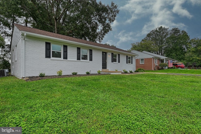 single story home featuring central AC and a front yard