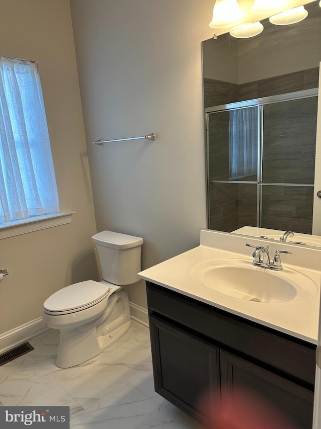 bathroom with a shower with door, toilet, and vanity