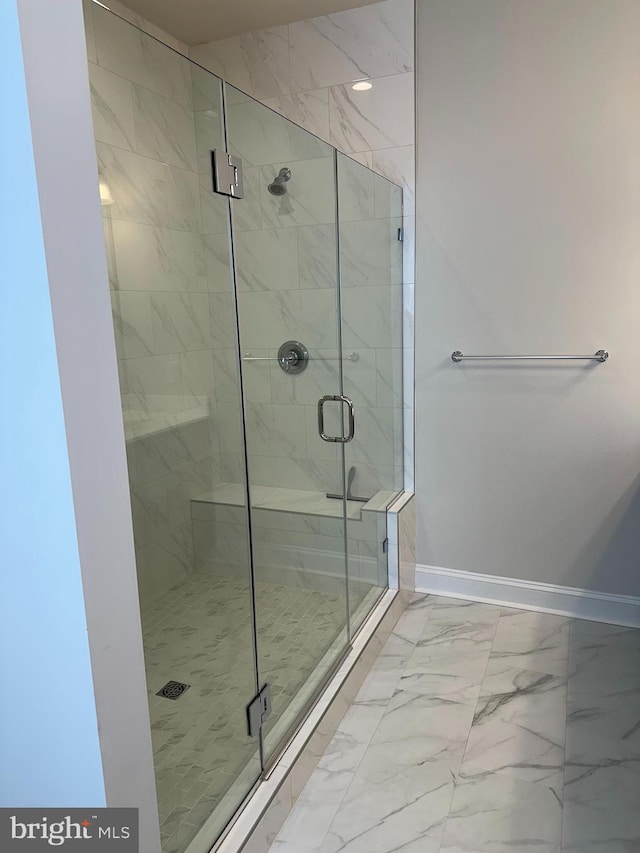 bathroom with a shower with door