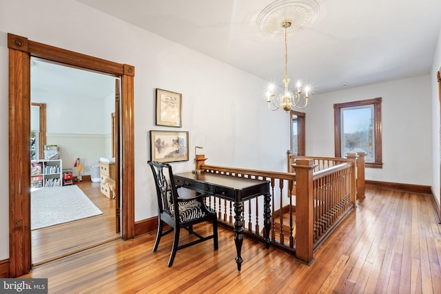 dining room with hardwood / wood-style flooring and a notable chandelier