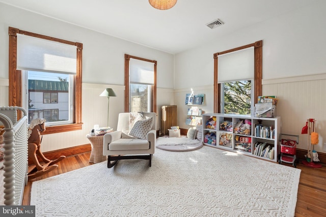 sitting room with radiator and hardwood / wood-style floors