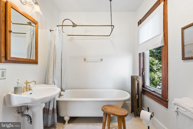 bathroom with a bathtub and radiator heating unit