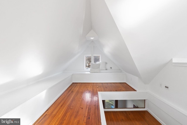 bonus room featuring vaulted ceiling and hardwood / wood-style floors