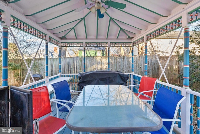 sunroom / solarium with lofted ceiling and ceiling fan