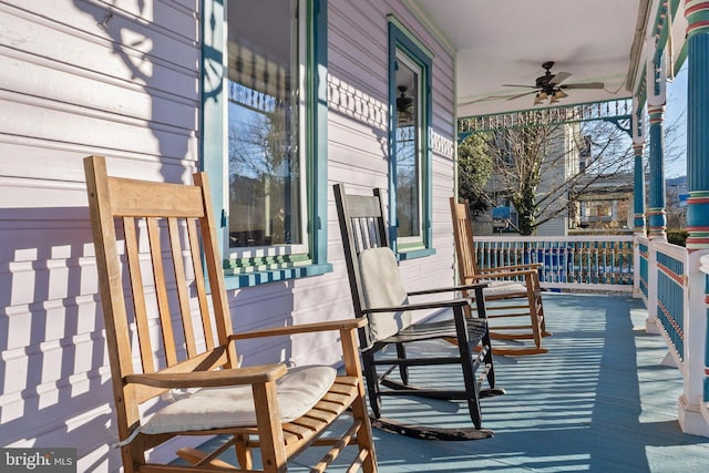 wooden deck featuring a porch and ceiling fan