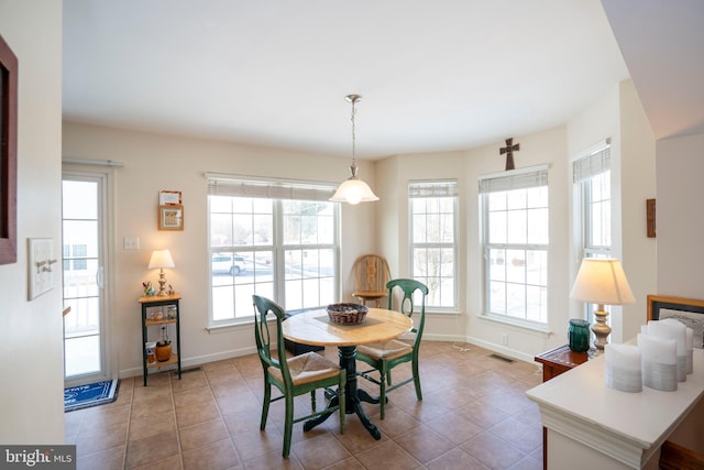 dining room with plenty of natural light and tile patterned flooring