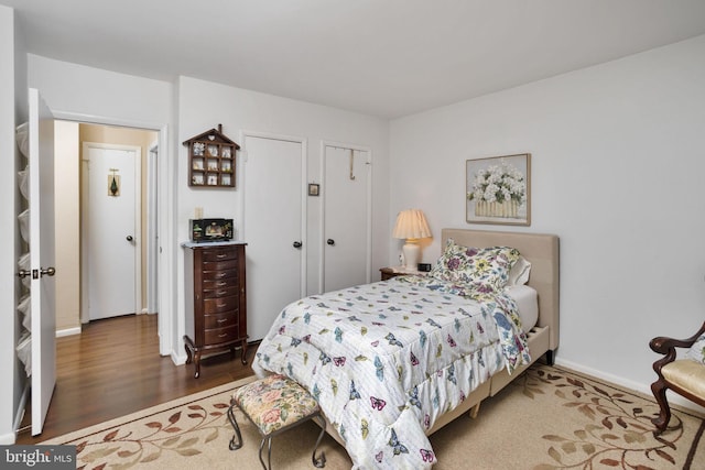 bedroom with dark hardwood / wood-style flooring