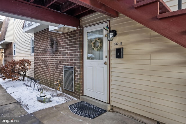 view of snow covered property entrance